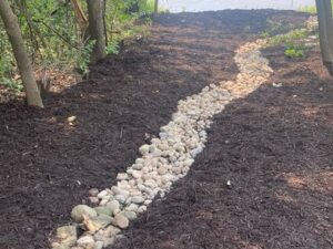 Landscape refresh with mulch and rock creek bed